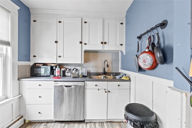 20 Cold Spring Pl, Woonsocket, RI 02895 - kitchen with stainless steel dishwasher, a sink, a baseboard heating unit, white cabinetry, and wainscoting