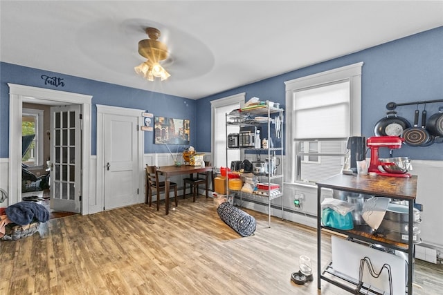 20 Cold Spring Pl, Woonsocket, RI 02895 - dining room featuring wood finished floors, a ceiling fan, and a wainscoted wall