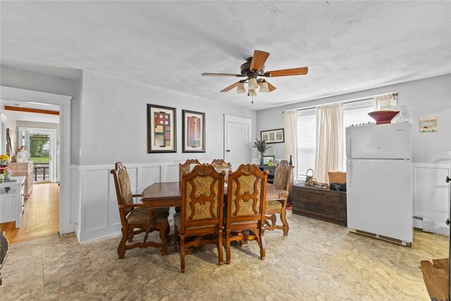 20 Cold Spring Pl, Woonsocket, RI 02895 - dining space with ceiling fan, a baseboard heating unit, and wainscoting