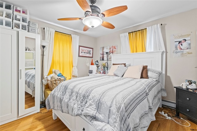 20 Cold Spring Pl, Woonsocket, RI 02895 - bedroom featuring light wood-style flooring, a baseboard heating unit, and ceiling fan