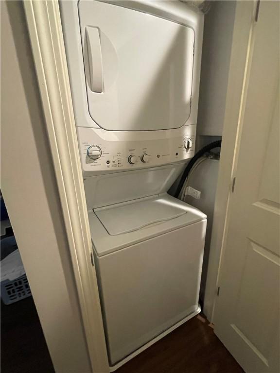 60 Saw Mill Dr Unit 303, North Kingstown, RI 02852 - laundry area with stacked washer and clothes dryer and dark wood finished floors