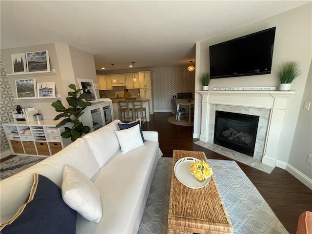60 Saw Mill Dr Unit 303, North Kingstown, RI 02852 - living room with baseboards, dark wood finished floors, wallpapered walls, and a premium fireplace