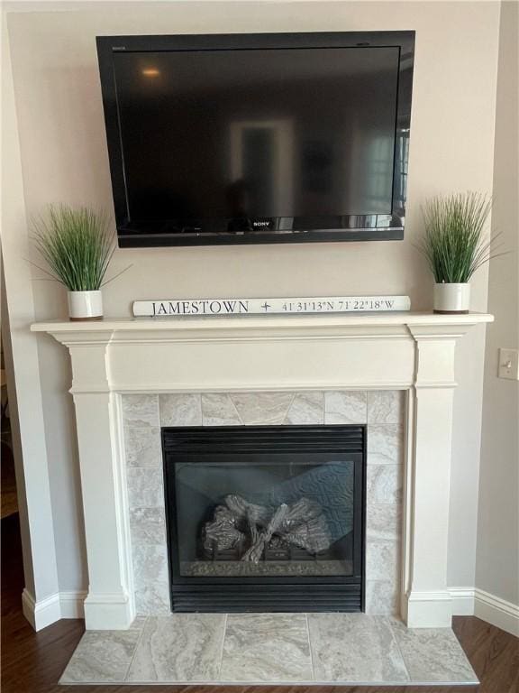 60 Saw Mill Dr Unit 303, North Kingstown, RI 02852 - detailed view of baseboards, wood finished floors, and a fireplace