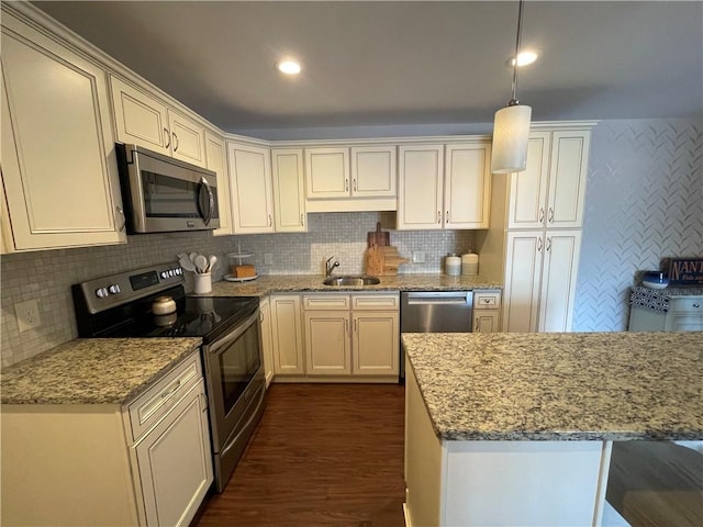 60 Saw Mill Dr Unit 303, North Kingstown, RI 02852 - kitchen with stainless steel appliances, a sink, dark wood-style floors, and backsplash