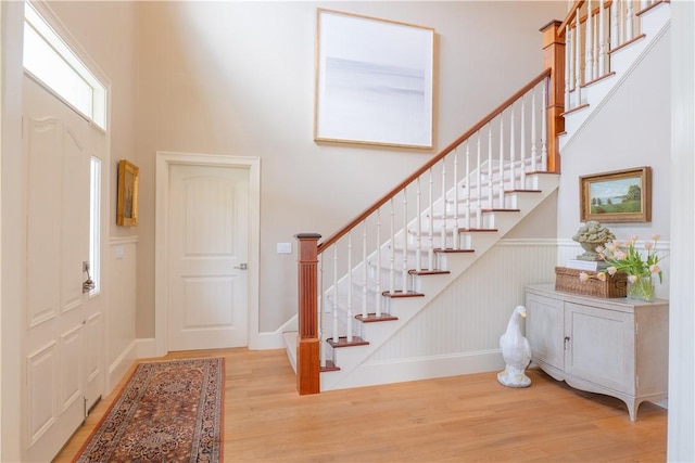 62 James Ct, Portsmouth, RI 02871 - foyer entrance with wood finished floors, a high ceiling, and stairway