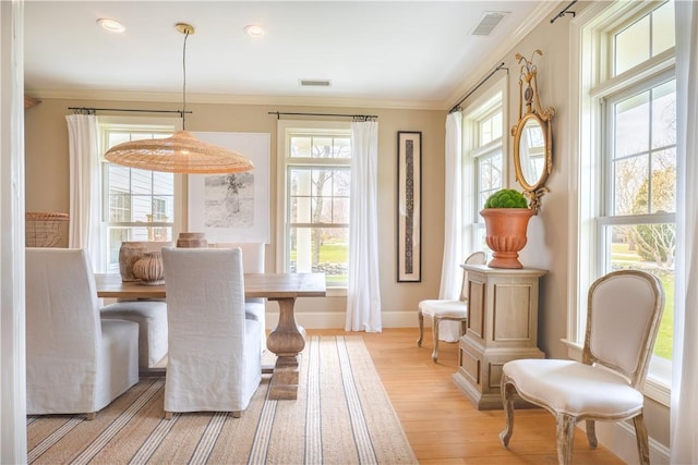 62 James Ct, Portsmouth, RI 02871 - dining space with healthy amount of natural light, light wood-style floors, and crown molding