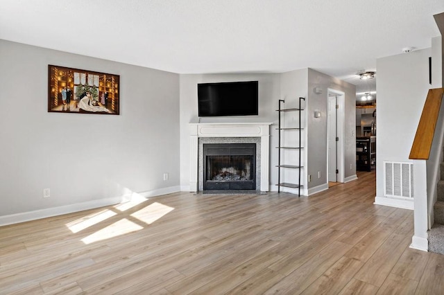 47 Morgan Ave Unit 45, Johnston, RI 02919 - unfurnished living room featuring light wood finished floors, a fireplace with flush hearth, baseboards, and a ceiling fan