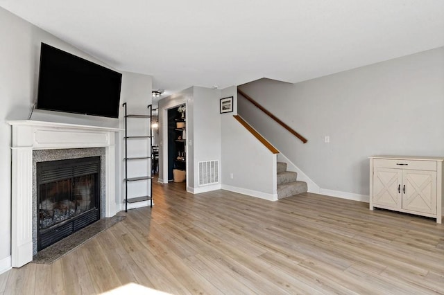 47 Morgan Ave Unit 45, Johnston, RI 02919 - unfurnished living room featuring stairs, light wood-type flooring, baseboards, and a fireplace