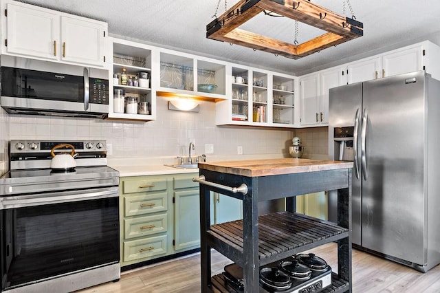 47 Morgan Ave Unit 45, Johnston, RI 02919 - kitchen with appliances with stainless steel finishes, green cabinets, open shelves, light wood-style flooring, and white cabinetry