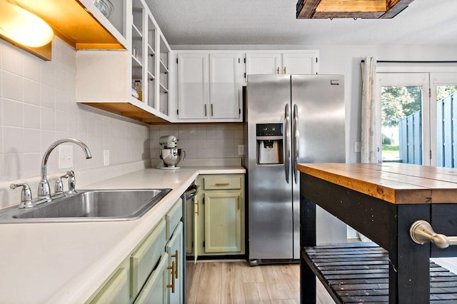 47 Morgan Ave Unit 45, Johnston, RI 02919 - kitchen with stainless steel fridge, a sink, green cabinetry, light countertops, and tasteful backsplash