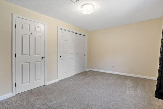 47 Morgan Ave Unit 45, Johnston, RI 02919 - unfurnished bedroom featuring carpet floors, a closet, a textured ceiling, and baseboards