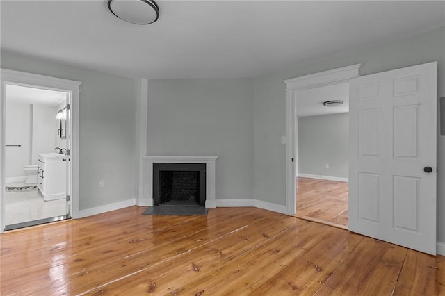 529 Rocky Hill Rd, Scituate, RI 02857 - unfurnished living room with hardwood / wood-style floors, a fireplace with flush hearth, and baseboards