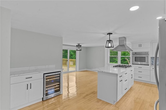 529 Rocky Hill Rd, Scituate, RI 02857 - kitchen with beverage cooler, appliances with stainless steel finishes, island exhaust hood, white cabinets, and recessed lighting
