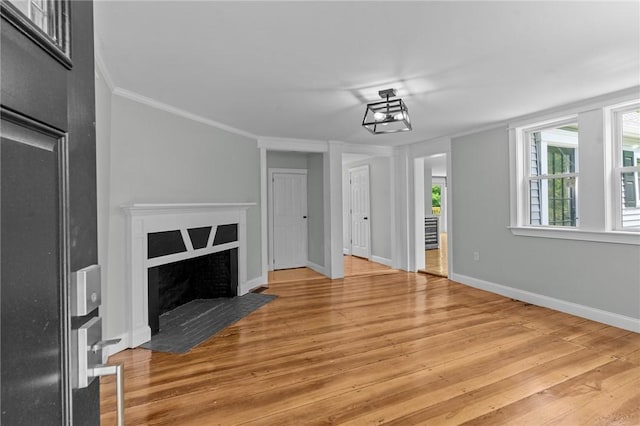 529 Rocky Hill Rd, Scituate, RI 02857 - unfurnished living room with ornamental molding, wood finished floors, baseboards, and a fireplace with flush hearth