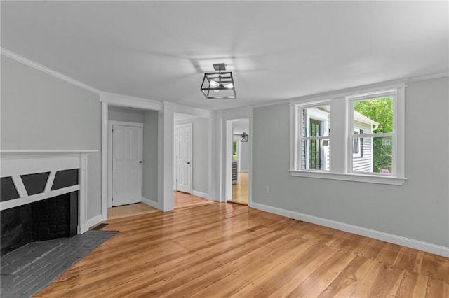 529 Rocky Hill Rd, Scituate, RI 02857 - unfurnished living room with hardwood / wood-style flooring, baseboards, crown molding, and a fireplace with flush hearth