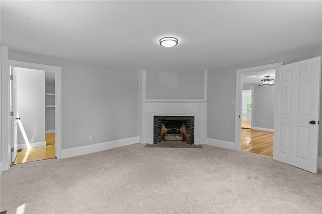 529 Rocky Hill Rd, Scituate, RI 02857 - unfurnished living room with carpet, a fireplace with flush hearth, and baseboards