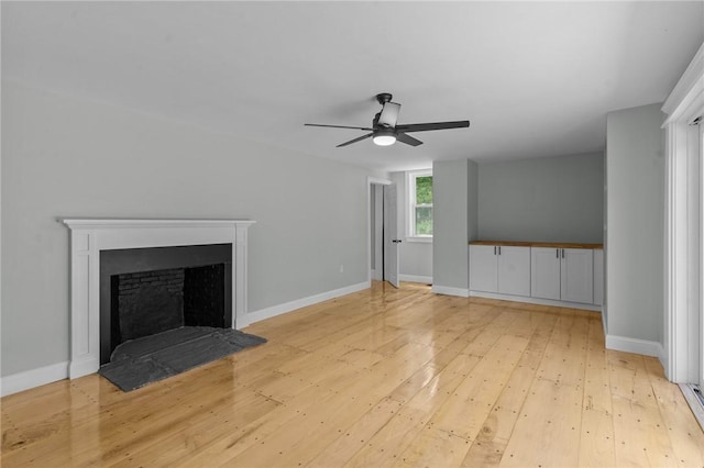 529 Rocky Hill Rd, Scituate, RI 02857 - unfurnished living room with a ceiling fan, light wood-style floors, a fireplace, and baseboards