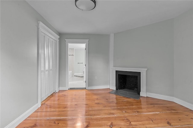 529 Rocky Hill Rd, Scituate, RI 02857 - unfurnished living room with a fireplace with flush hearth, wood finished floors, and baseboards