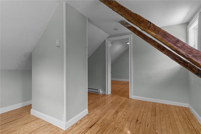 529 Rocky Hill Rd, Scituate, RI 02857 - additional living space with baseboard heating, vaulted ceiling, wood finished floors, and baseboards