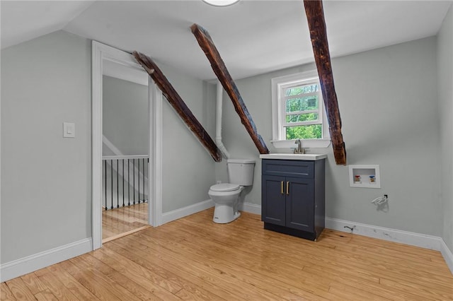529 Rocky Hill Rd, Scituate, RI 02857 - bathroom with wood finished floors, toilet, vaulted ceiling, vanity, and baseboards