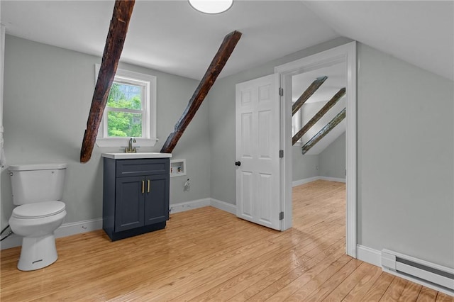 529 Rocky Hill Rd, Scituate, RI 02857 - bathroom with a baseboard heating unit, wood finished floors, vaulted ceiling, toilet, and vanity