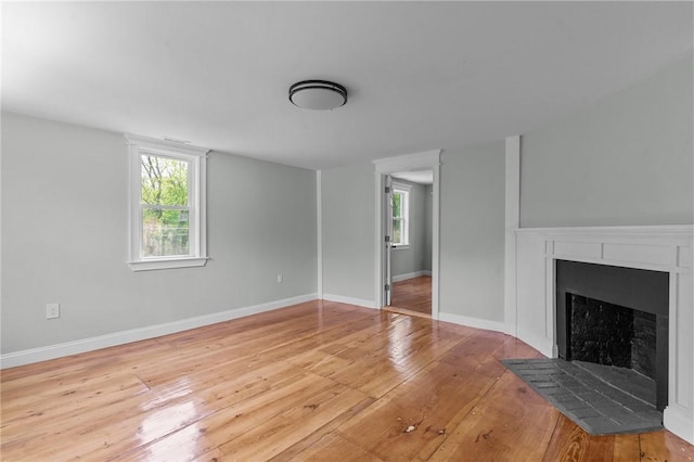 529 Rocky Hill Rd, Scituate, RI 02857 - unfurnished living room featuring wood-type flooring, a fireplace with flush hearth, and baseboards