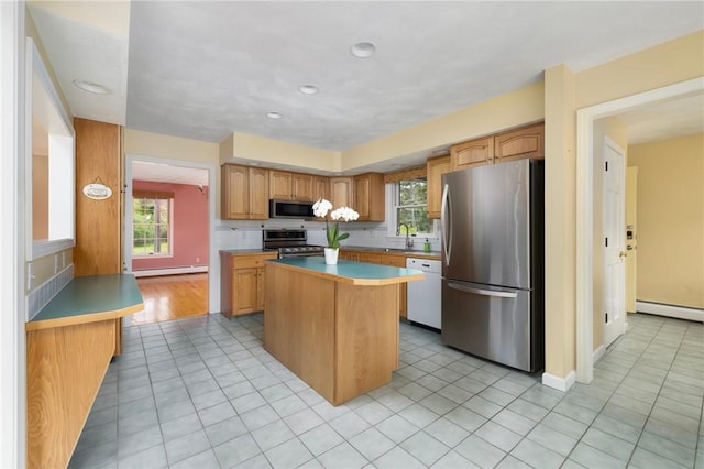 30 Walden Way S, Kingstown, RI 02879 - kitchen with stainless steel appliances, a center island, light tile patterned floors, a baseboard radiator, and baseboard heating