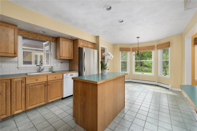 30 Walden Way S, Kingstown, RI 02879 - kitchen with white dishwasher, freestanding refrigerator, a baseboard heating unit, a sink, and light tile patterned floors