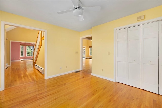30 Walden Way S, Kingstown, RI 02879 - unfurnished bedroom featuring baseboard heating, light wood-style floors, baseboards, a baseboard radiator, and a closet