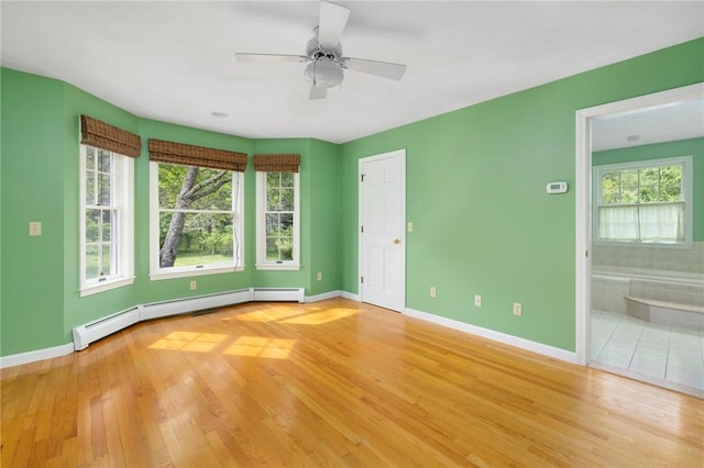 30 Walden Way S, Kingstown, RI 02879 - unfurnished room featuring wood finished floors, baseboards, a ceiling fan, and baseboard heating
