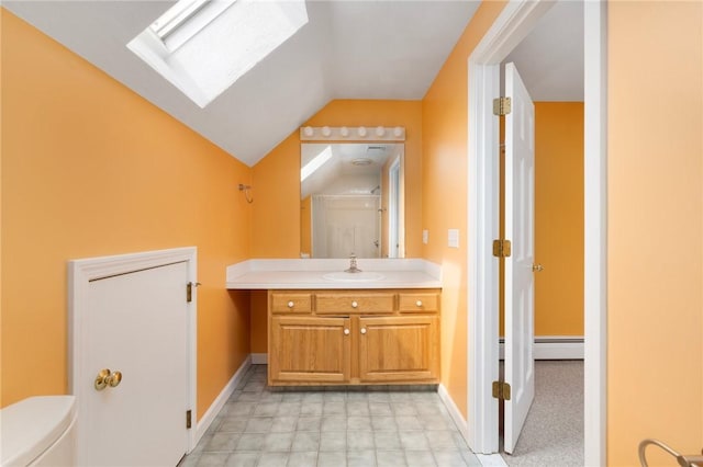 30 Walden Way S, Kingstown, RI 02879 - bathroom with a skylight, a baseboard radiator, vanity, baseboards, and vaulted ceiling
