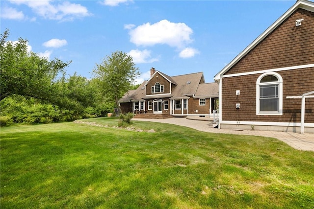 30 Walden Way S, Kingstown, RI 02879 - rear view of house with a lawn, a patio, and a chimney
