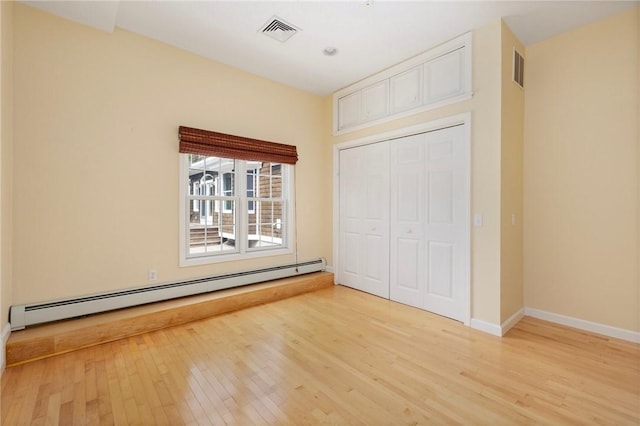 30 Walden Way S, Kingstown, RI 02879 - unfurnished bedroom with a baseboard radiator, light wood-style flooring, baseboards, and a closet