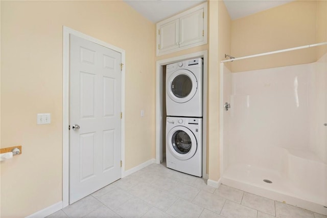 30 Walden Way S, Kingstown, RI 02879 - laundry area with stacked washing machine and dryer, baseboards, and light tile patterned floors