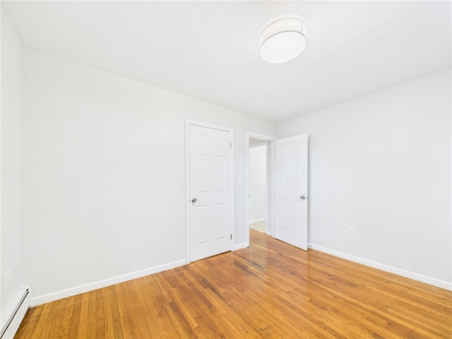 5 Conca St, North Providence, RI 02904 - unfurnished room with a baseboard radiator, baseboards, and light wood finished floors