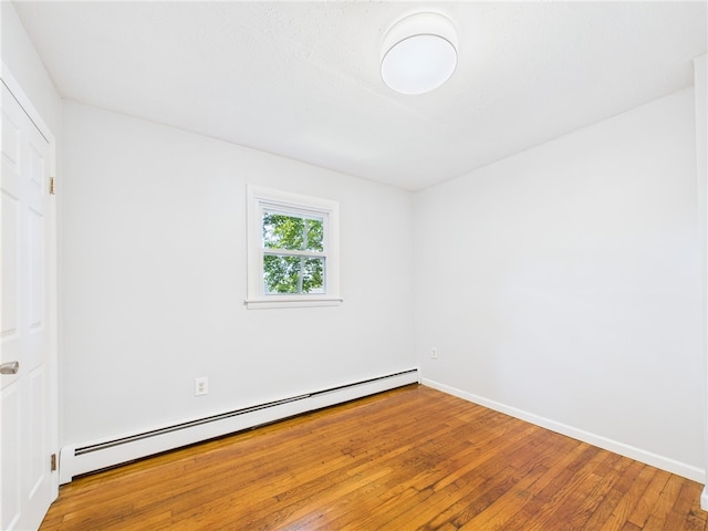 5 Conca St, North Providence, RI 02904 - unfurnished bedroom with a baseboard radiator, hardwood / wood-style flooring, and baseboards