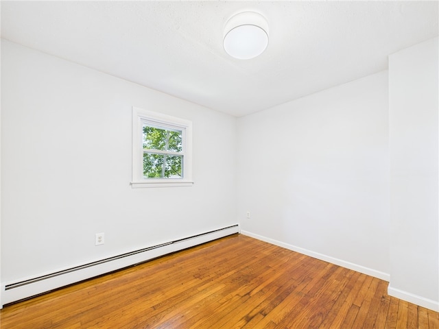 5 Conca St, North Providence, RI 02904 - empty room with baseboard heating, hardwood / wood-style floors, and baseboards
