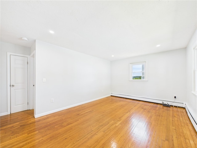 5 Conca St, North Providence, RI 02904 - spare room with light wood-style floors, a baseboard heating unit, a baseboard radiator, baseboards, and recessed lighting