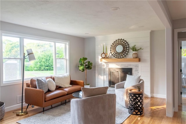 24 W Knollwood Cir, North Kingstown, RI 02852 - living area featuring wood finished floors, a brick fireplace, and baseboards