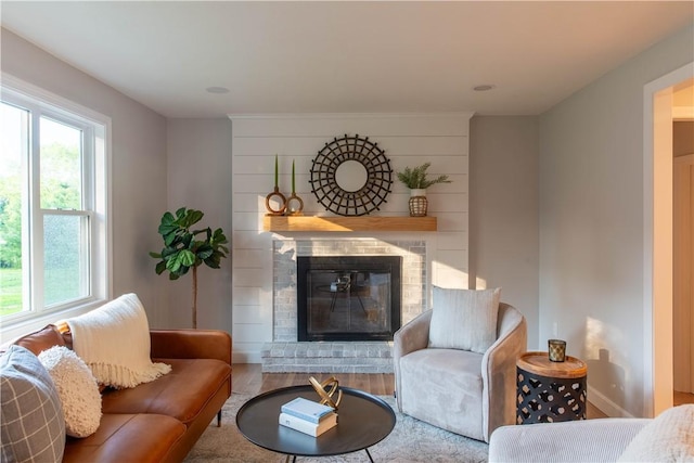24 W Knollwood Cir, North Kingstown, RI 02852 - living room with a glass covered fireplace, wood finished floors, and baseboards