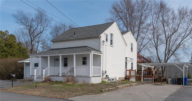 40 Cedar St, Johnston, RI 02919 - view of front of home with covered porch, a shingled roof, and asphalt driveway