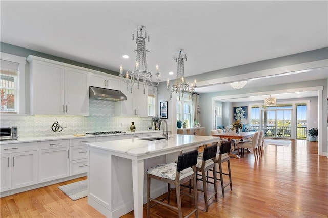 171 Leeshore Ln, Tiverton, RI 02878 - kitchen with a chandelier, under cabinet range hood, a sink, an island with sink, and recessed lighting