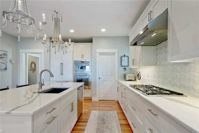 171 Leeshore Ln, Tiverton, RI 02878 - kitchen with a chandelier, a sink, under cabinet range hood, stainless steel appliances, and light wood-style floors