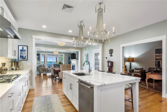 171 Leeshore Ln, Tiverton, RI 02878 - kitchen featuring a sink, open floor plan, wall chimney exhaust hood, stainless steel appliances, and a chandelier