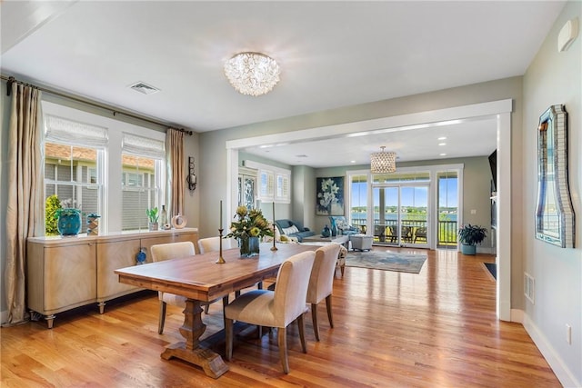 171 Leeshore Ln, Tiverton, RI 02878 - dining space with a chandelier, light wood finished floors, healthy amount of natural light, and baseboards