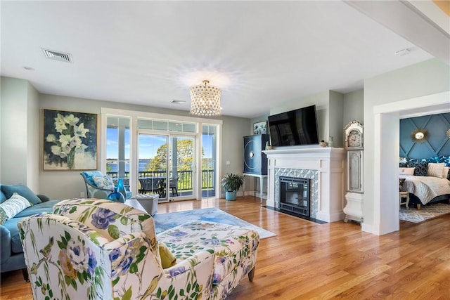 171 Leeshore Ln, Tiverton, RI 02878 - living area featuring a chandelier, wood finished floors, and a premium fireplace