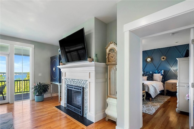 171 Leeshore Ln, Tiverton, RI 02878 - living area featuring wood finished floors, a tile fireplace, and baseboards