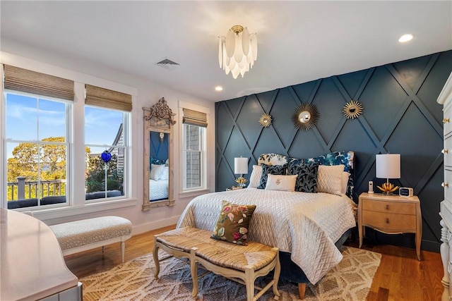 171 Leeshore Ln, Tiverton, RI 02878 - bedroom featuring baseboards, wood finished floors, recessed lighting, a decorative wall, and a chandelier