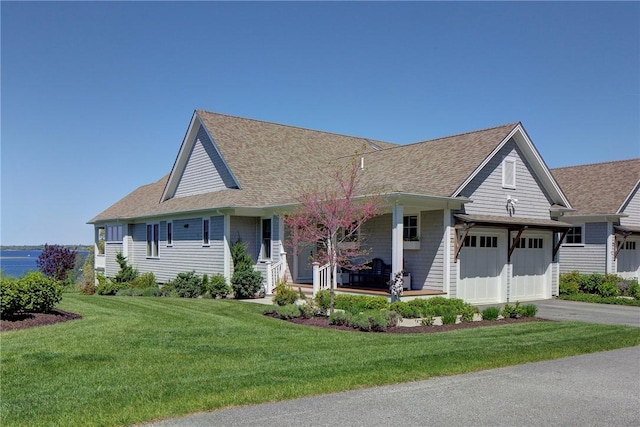 171 Leeshore Ln, Tiverton, RI 02878 - view of front of home featuring a shingled roof, covered porch, asphalt driveway, a front lawn, and a garage