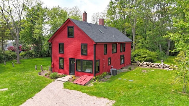 259 Green Hill Beach Rd, South Kingstown, RI 02879 - view of front of property with a chimney, central AC, a shingled roof, and a front lawn